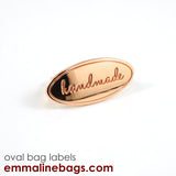 Metal Bag Label: Oval with "Handmade" - Emmaline Bags Inc.